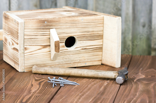 Fototapeta Homemade birdhouse made of wood under construction