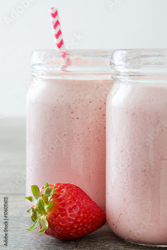 Delicious strawberry smoothie on rustic wood
