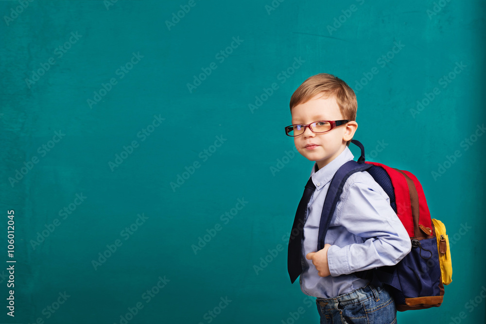 Cheerful smiling little kid with big backpack