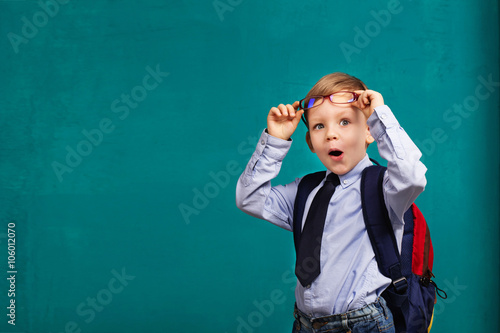 Canvas Print little Boy in eyeglasses with big backpack