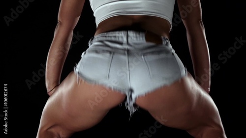 Professional booty dancer actively moving in the studio. Black
