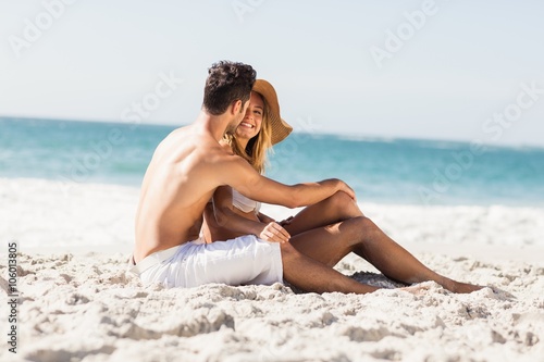 Young couple sitting on sand