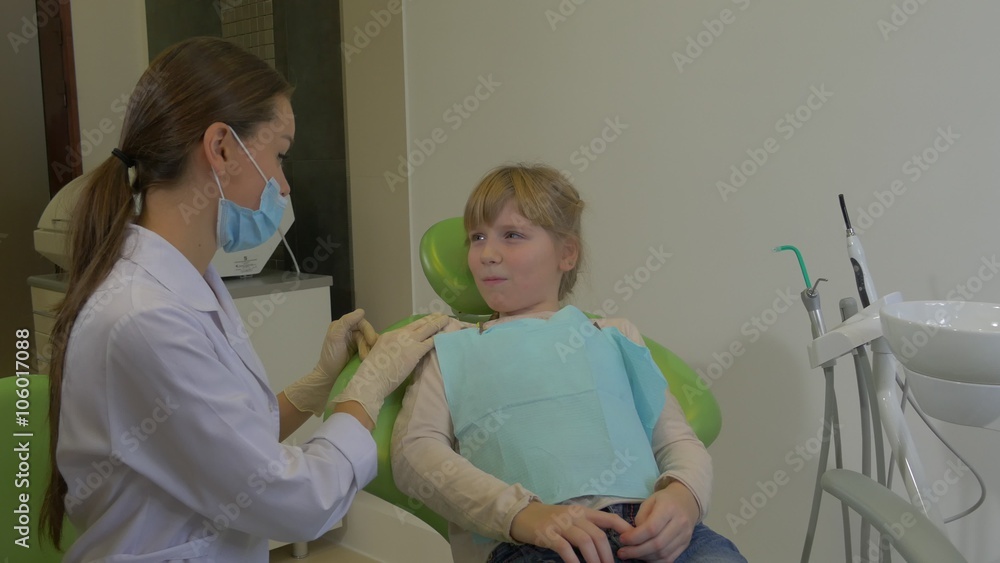 Dentist Calms a Girl Kid Nods Agrees Young Doctor is Going to Examine or Treat a Teeth of a Patient at Dental Treatment Room Visit to the Dentist Dentist Calms a Girl Kid Nods Agrees Young Doctor is Going to Examine or Treat a Teeth of a Patient at Dental Treatment Room Visit to the Dentist