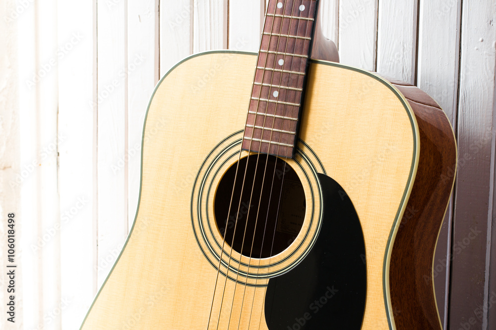 acoustic guitar on a white wooden background close-up