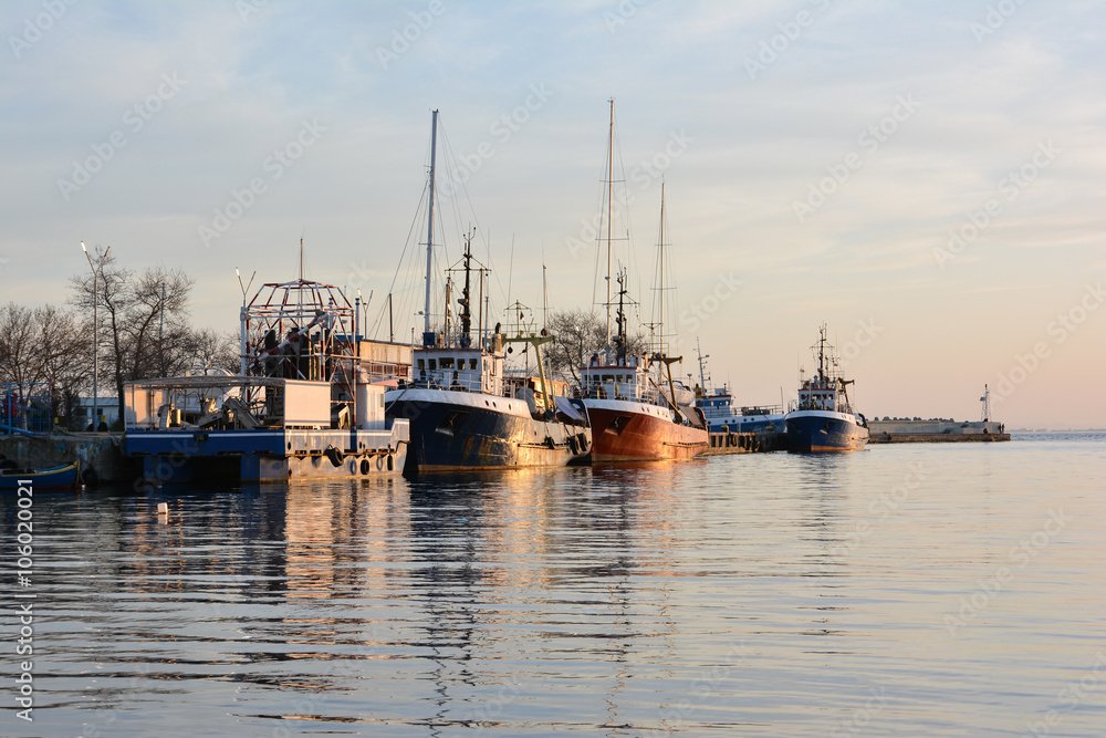 Fishing trawlers at sunset