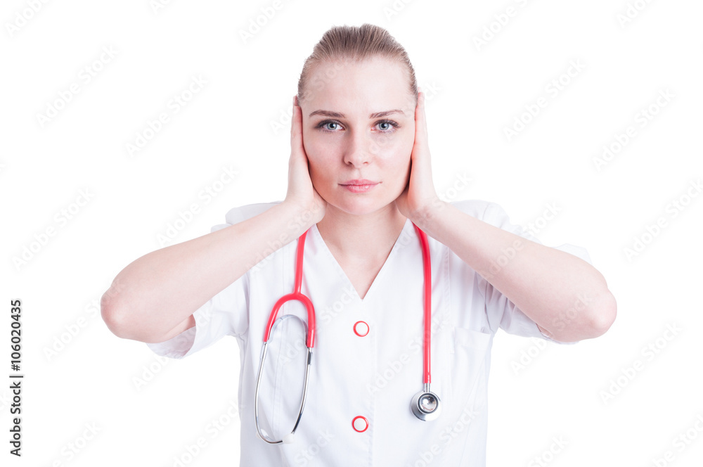 Attractive young woman doctor covering her ears with hands Attractive young woman doctor covering her ears with hands