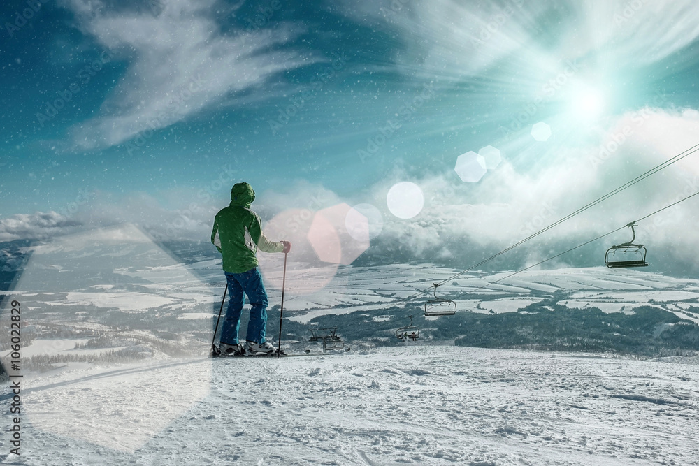 Skier stay on the peak of mountain in sunny day. Skier stay on the peak of mountain in sunny day.
