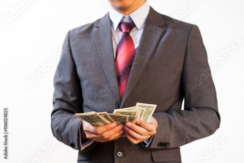 Business man counting money on white isolated background