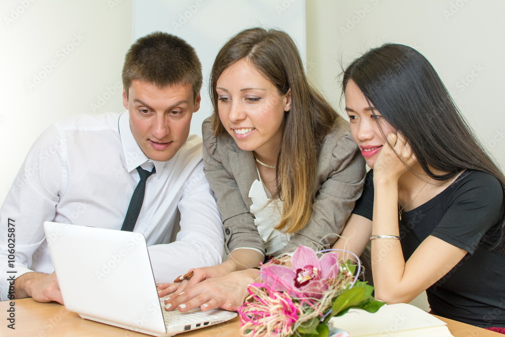 Multicultural team looking at a tablet