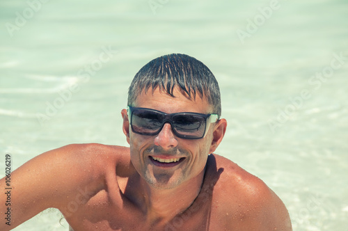 Happy man relaxing on a beautiful tropical beach © jovannig