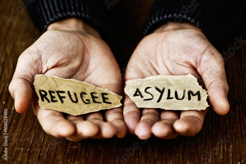 pieces of paper with words refugee and asylum photo