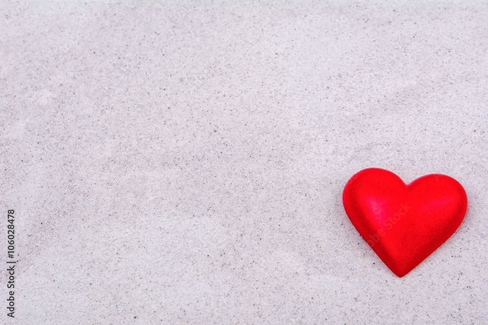 Fototapeta premium Red heart on a sand background