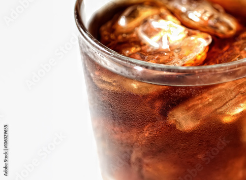 Cold cola with ice in a glass on a white background
