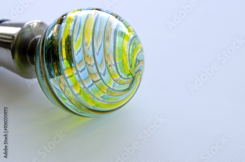 Decorative bottle cap from Murano glass on a light background 