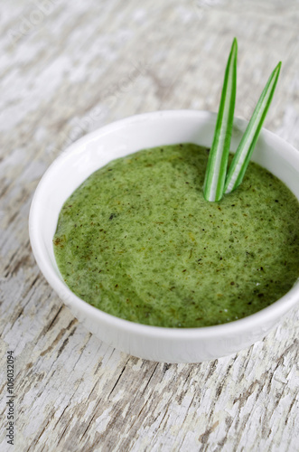 Organic herbal face and body mask (scrub) in a small white bowl close up