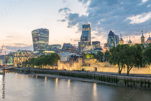 London  UK. City buildings along Thames river at dusk