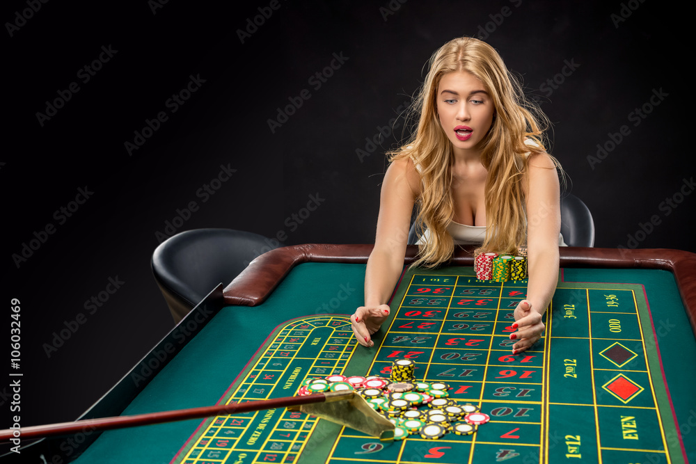 Young pretty women playing roulette wins at the casino Young pretty women playing roulette wins at the casino