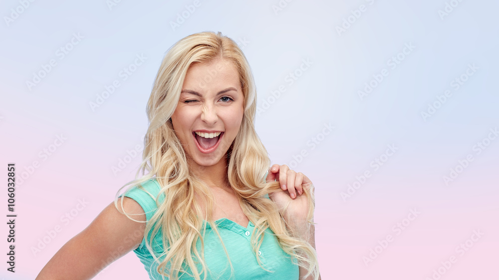 smiling young woman holding her strand of hair smiling young woman holding her strand of hair