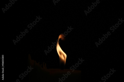 A small flame in the darkness.