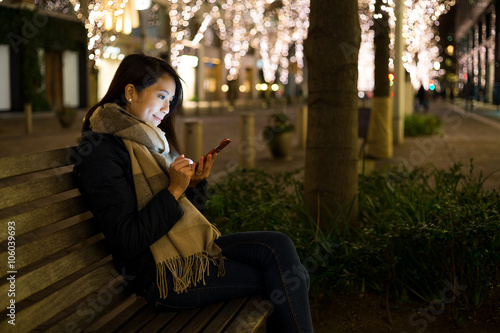 Photography Woman use of mobile phone at night