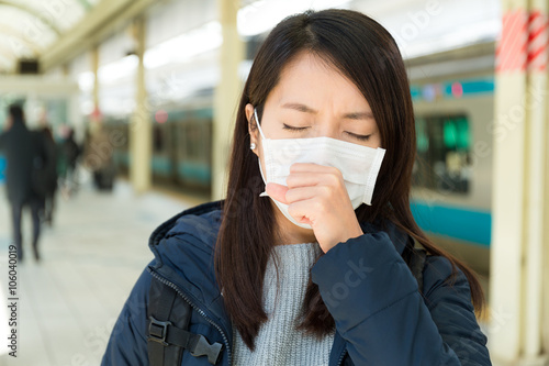 Woman wearing face mask at train platform