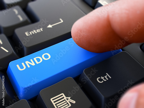 Undo - Written on Blue Keyboard Key. Male Hand Presses Button on Black PC Keyboard. Closeup View. Blurred Background. 3D Render.