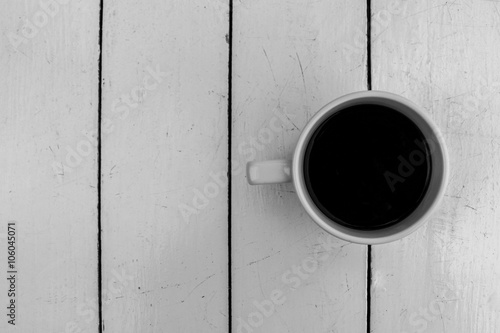Top view of black coffee cup on white wooden table