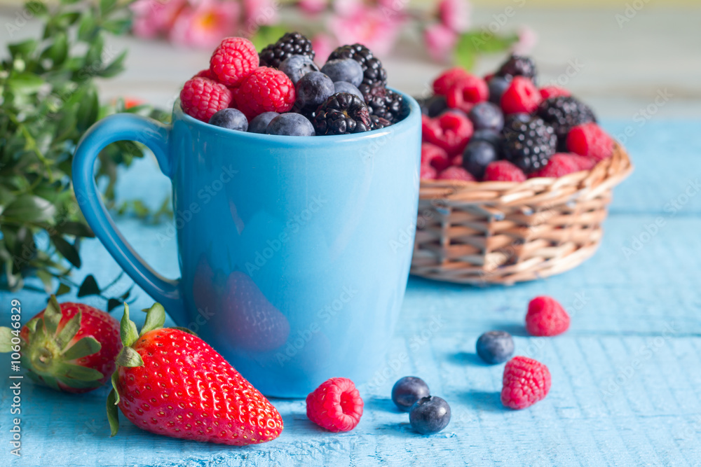 Berries spring fruits on blue wooden boards abstract still life
Berries spring fruits on blue wooden boards abstract still life