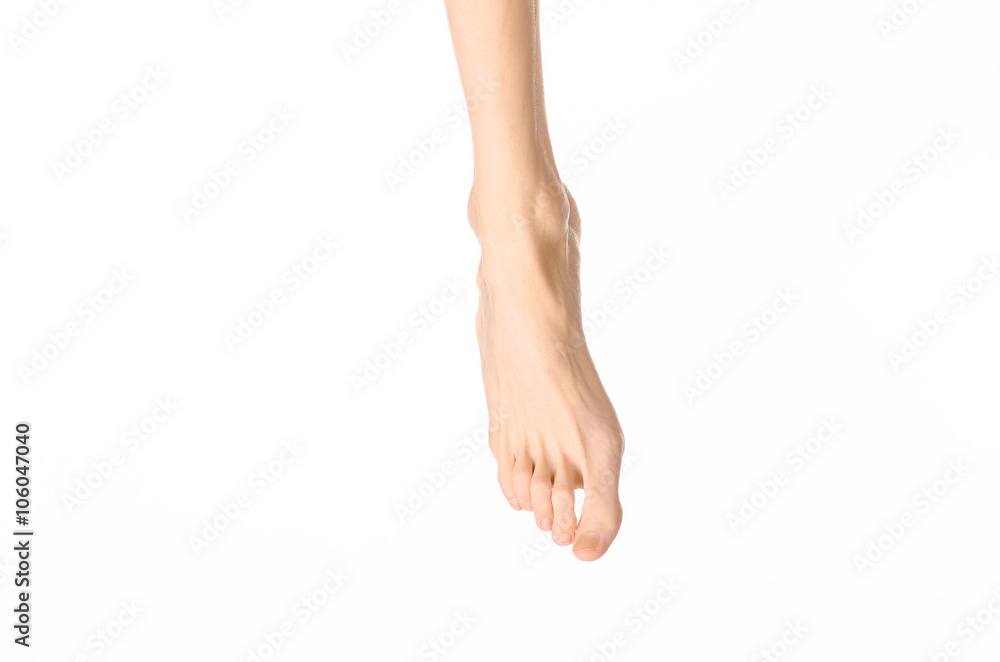 Pedicure and foot care topic: the naked man's legs isolated on white background in studio