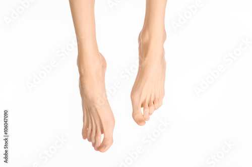 Pedicure and foot care topic: the naked man's legs isolated on white background in studio