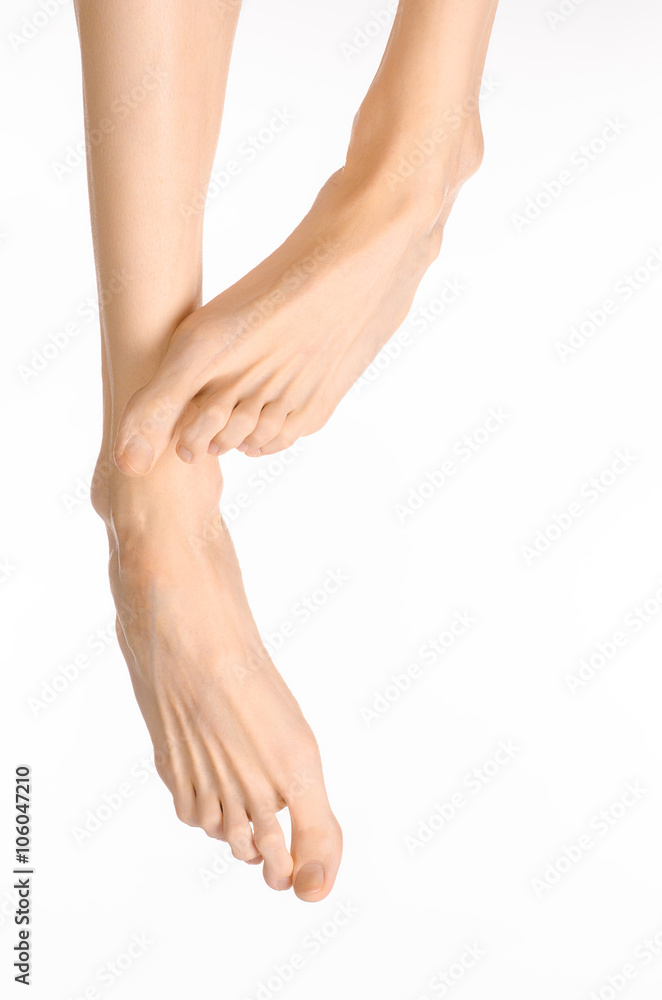 Pedicure and foot care topic: the naked man's legs isolated on white background in studio Pedicure and foot care topic: the naked man's legs isolated on white background in studio