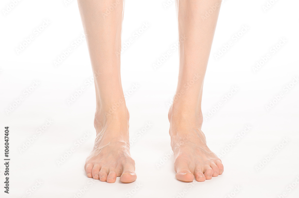Pedicure and foot care topic: the naked man's legs isolated on white background in studio Pedicure and foot care topic: the naked man's legs isolated on white background in studio