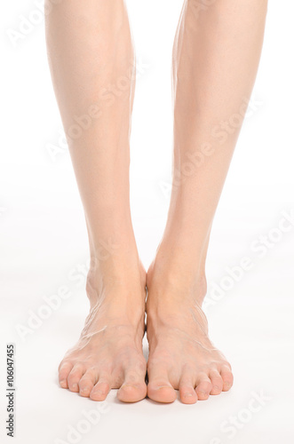 Fototapeta Naklejka Na Ścianę i Meble -  Pedicure and foot care topic: the naked man's legs isolated on white background in studio