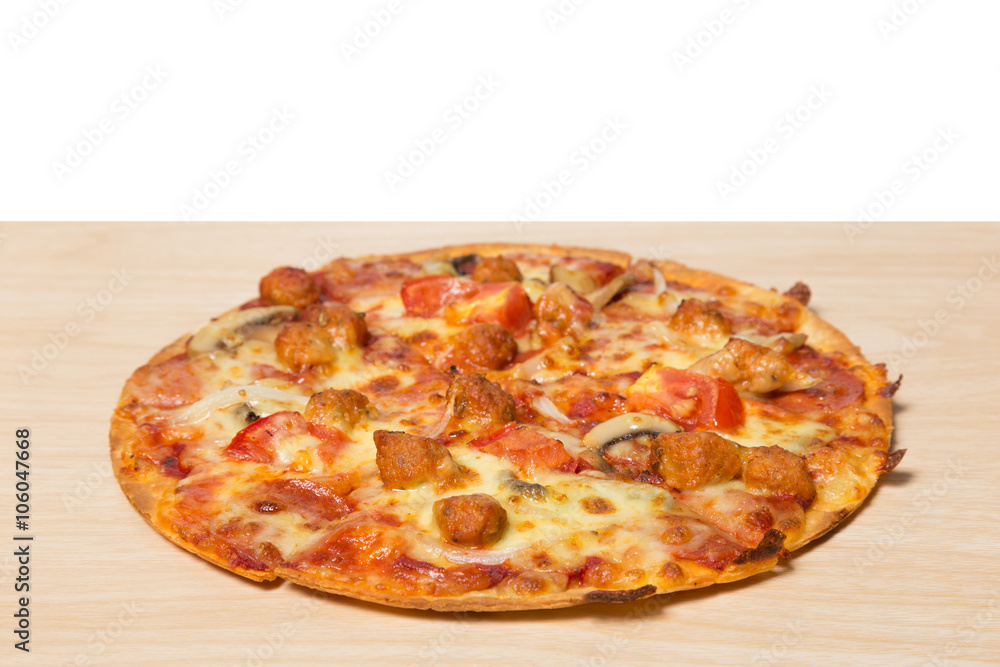 Pizza with sliced vegetables on wood