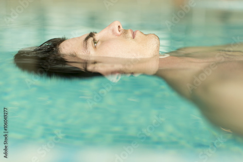 Man floating in the pool