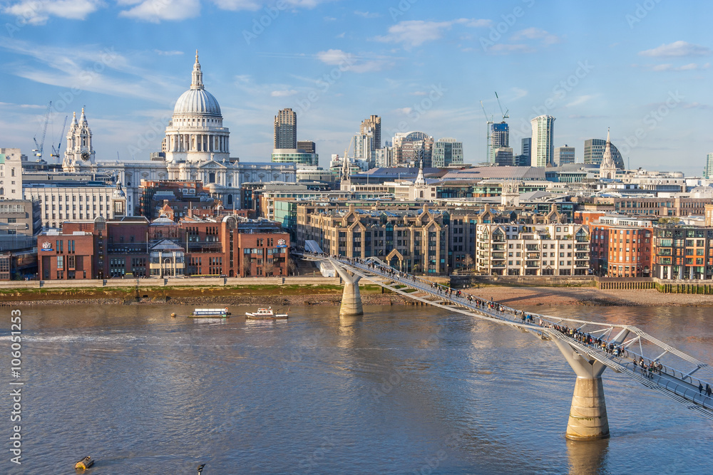 Millennium Bridge across Thames River and St. Paul's Cathedral in  London