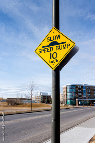 Slow Speed Bump Road Sign on Residential Street
