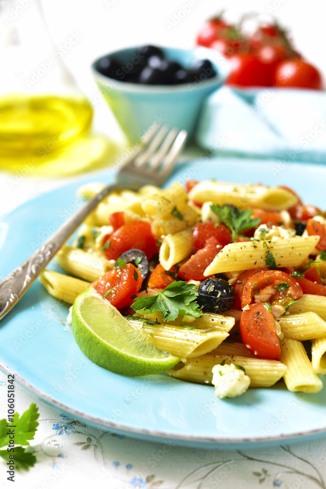 Pasta salad with cherry tomatoes,olives and feta cheese.