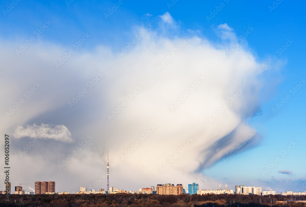 clouds in snow weather front over city in spring