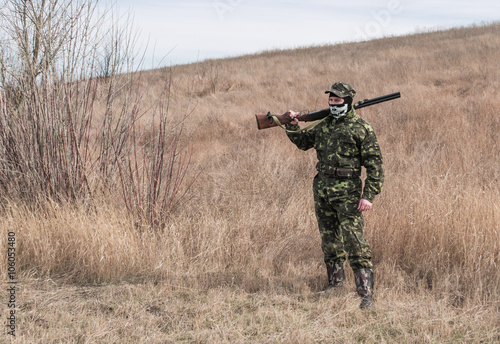 Hunter during a recreation, rifle on shoulder
