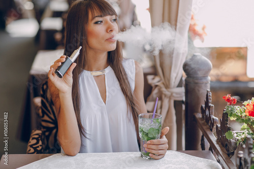 girn in cafe with E-Cigarette photo