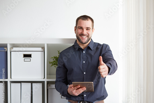 Happy businessman with digital tablet photo