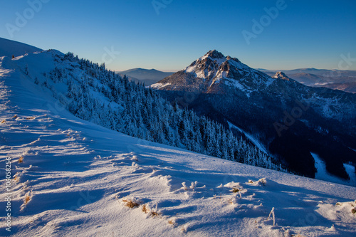 Winter landscape with dominant peak © denisveselyxx