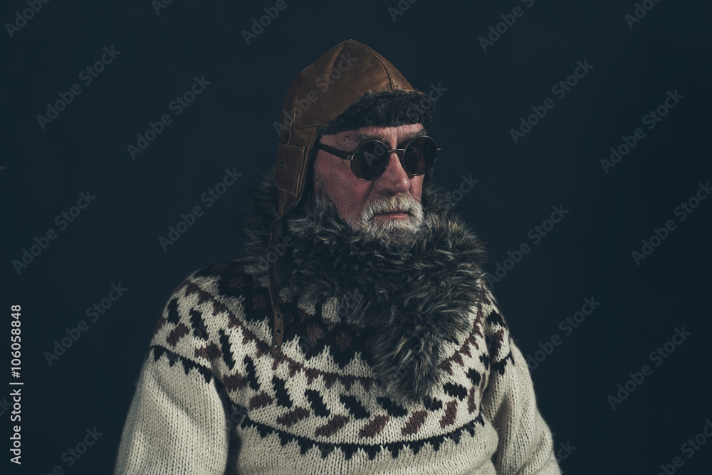 Vintage senior man with knitted sweater, fur collar and sunglass