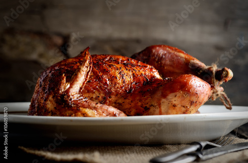 grilled chicken on a oval dish on a wooden background
