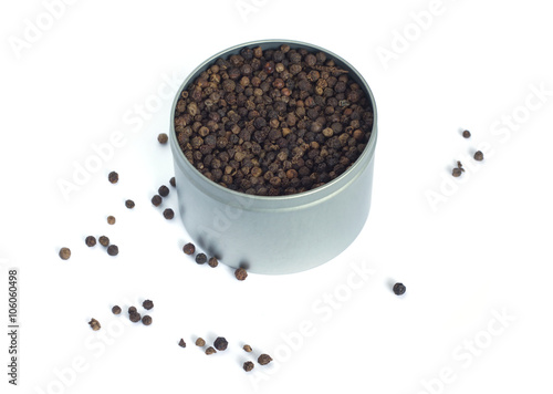 Still-life with a black pepper in silver metal jar isolated on white background. Top view photo closeup