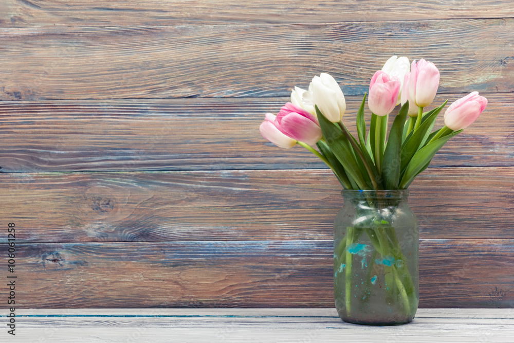 Colorful tulips flowers on wooden table. Top view with copy space. Toned picture by instagram filter Colorful tulips flowers on wooden table. Top view with copy space. Toned picture by instagram filter