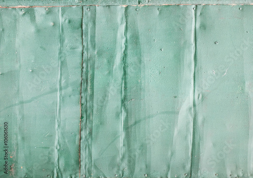 Old metal with green cracked paint. Vintage metal background. Abstract cracelures photo