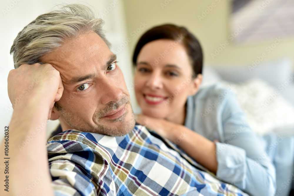 Middle-aged couple relaxing in sofa at thome Middle-aged couple relaxing in sofa at thome
