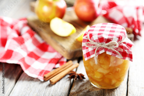 Apple jam in jar on a grey wooden table